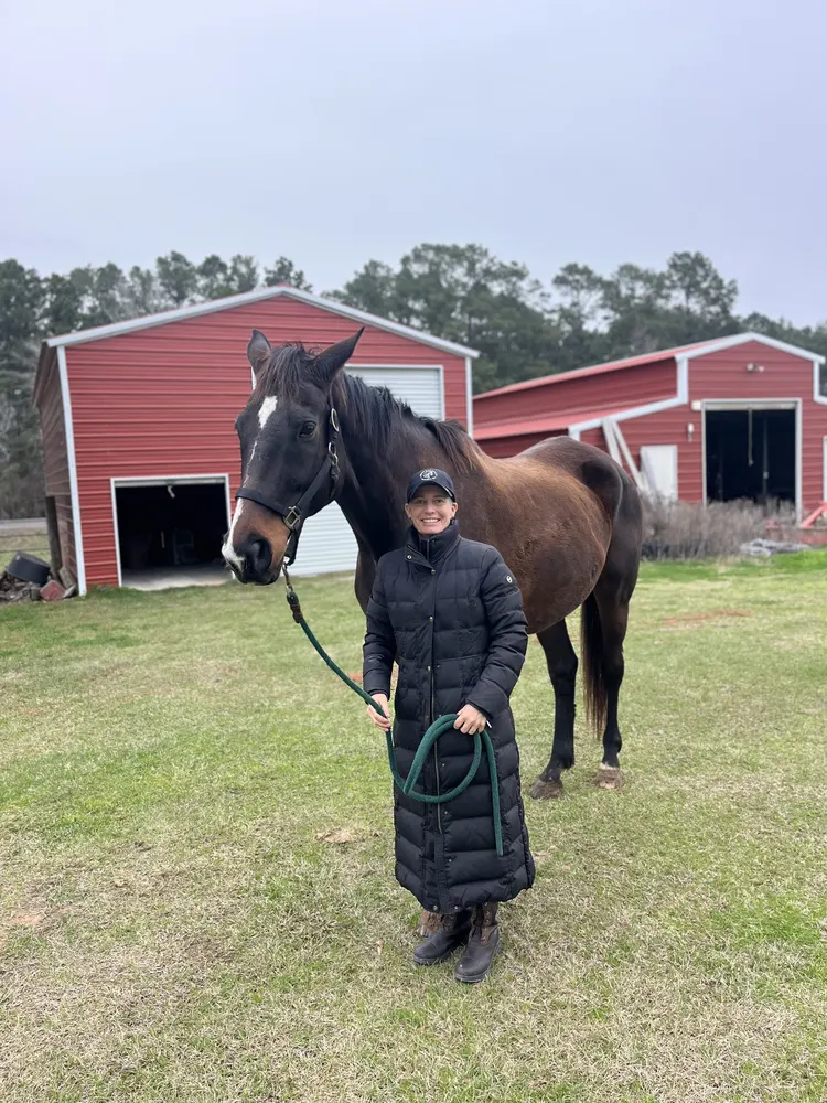 Susan McGinnis with a client's horse before a fitting